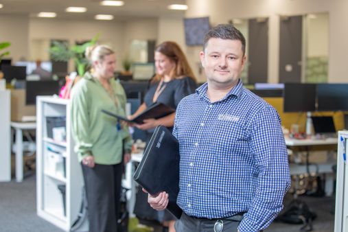 Probation officer standing in office with a folder